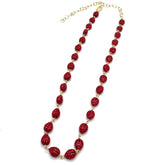 Red beaded necklace with gold chain on a white background