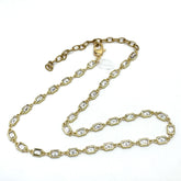 Gold chain necklace with clear stones on a white background
