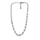 Silver necklace with clear stones on a white background