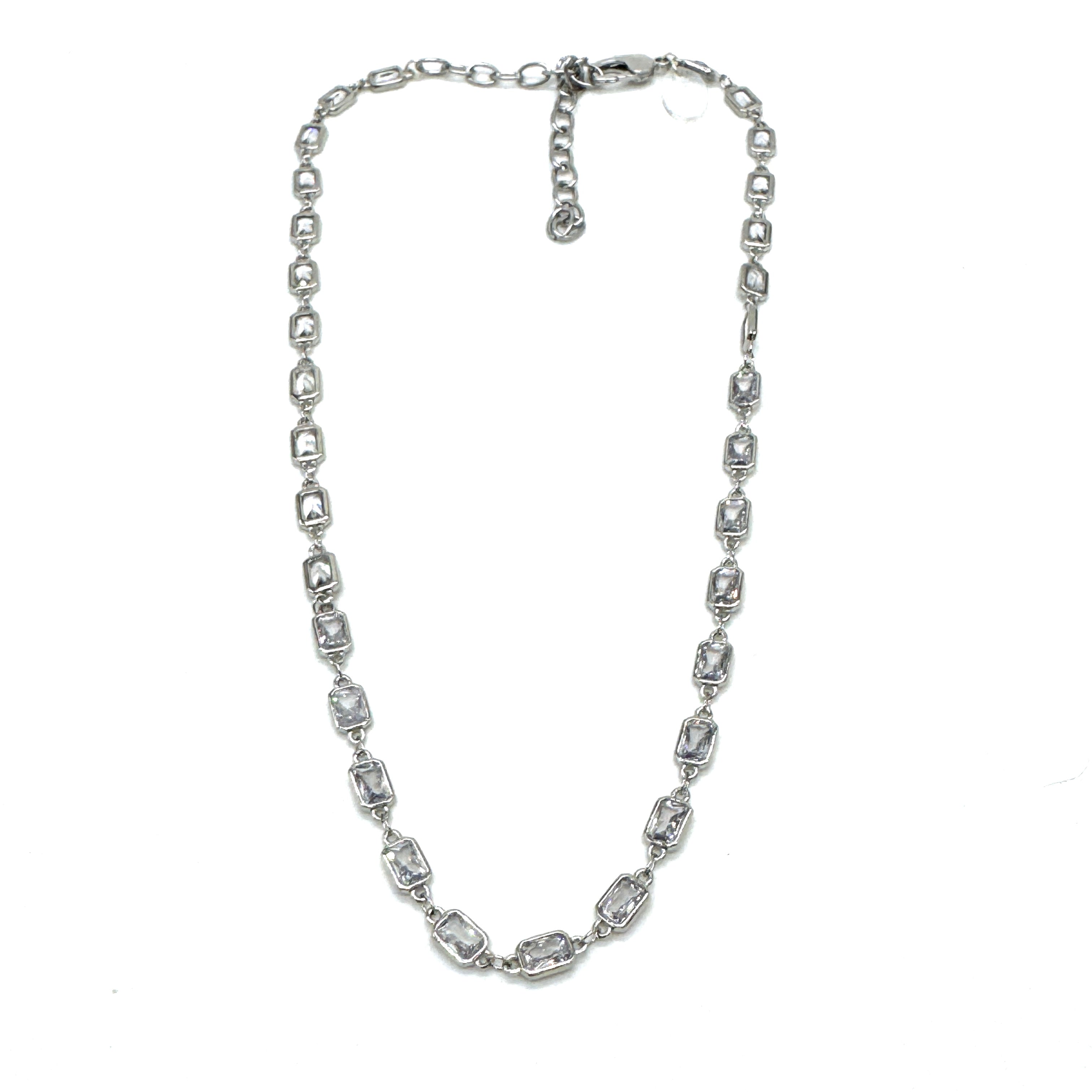 Silver necklace with clear stones on a white background