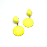 Pair of yellow earrings on a white background