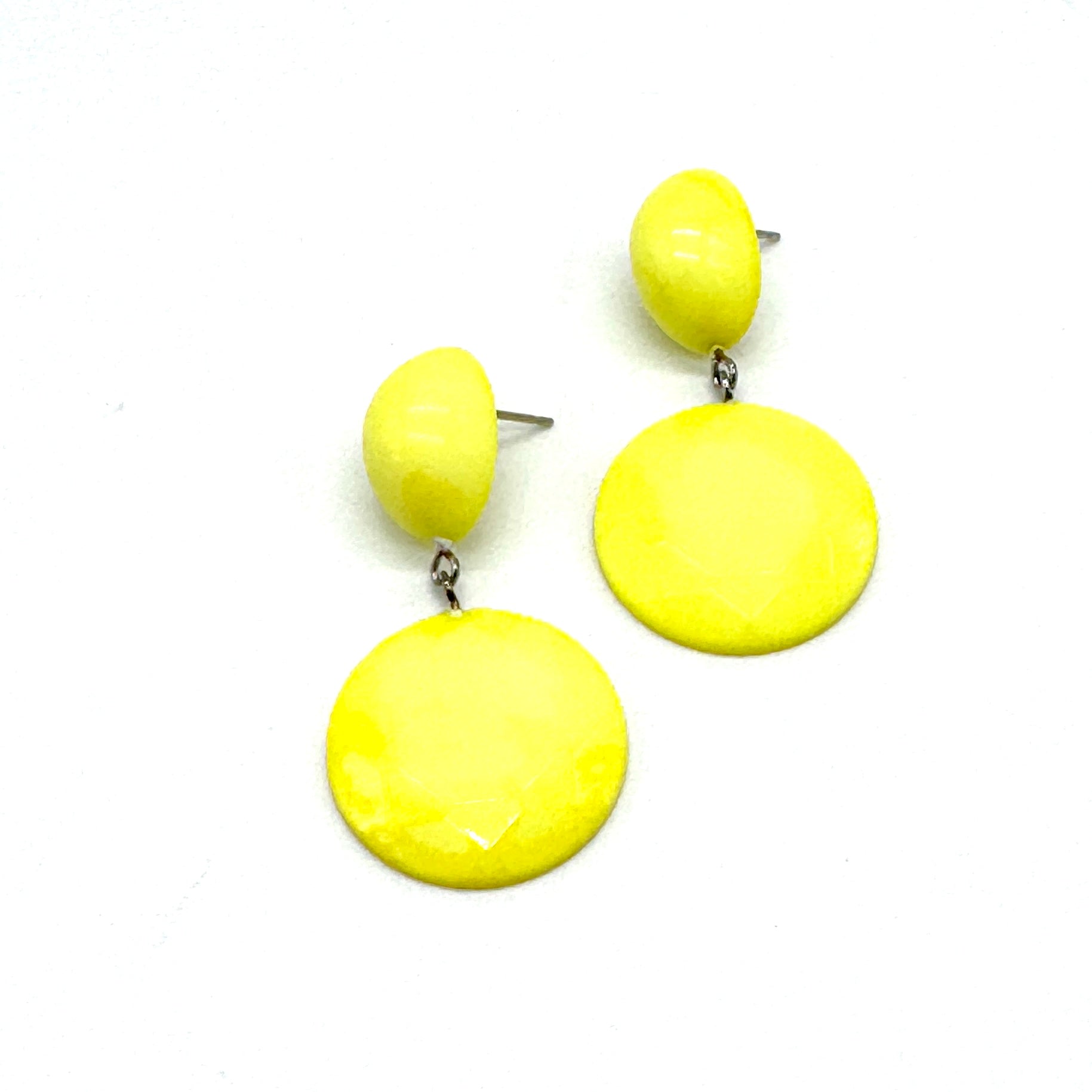 Pair of yellow earrings on a white background