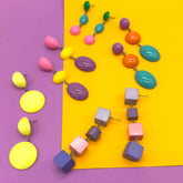 Colorful necklace and earrings on a purple and yellow background