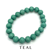 Single lucite beaded bracelet in teal on a white background