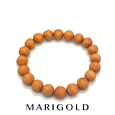 Single lucite beaded bracelet in marigold on a white background