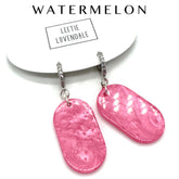 Pink earrings on a white background with &