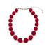 Necklace with red beads on a white background