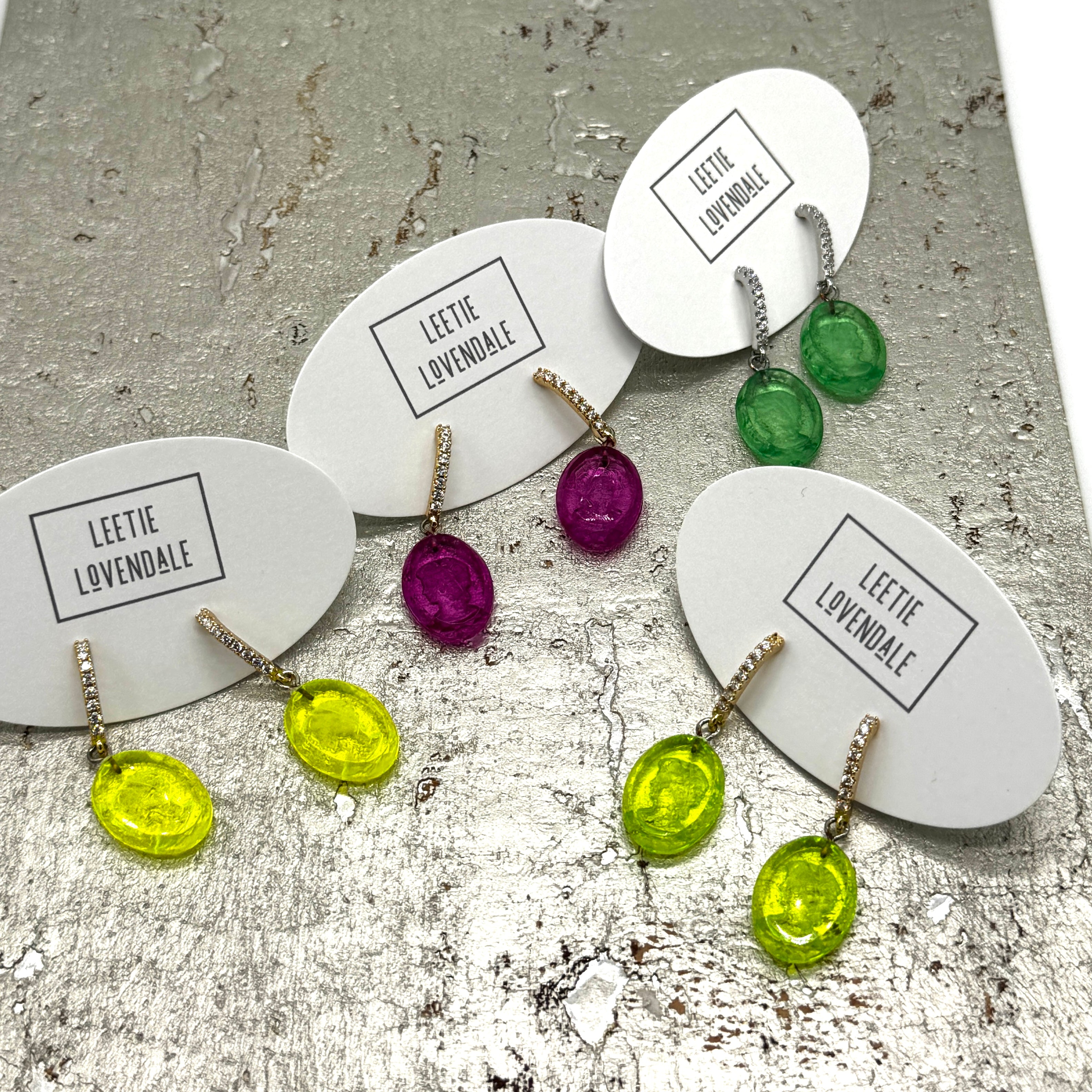 Colorful earrings on display with &