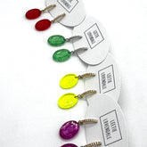 Colorful earrings on white cards with &