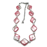Necklace with pink and white beads on a white background