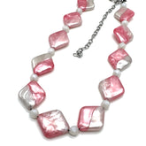 Necklace with pink and white beads on a white background