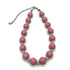 Necklace with pink and green beads on a white background