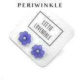 Periwinkle flower stud earrings on a white background