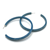 Large crackled blue lucite hoop earrings.