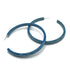 Large crackled blue lucite hoop earrings.