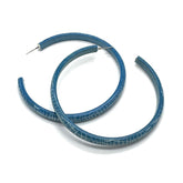 Large crackled blue lucite hoop earrings.