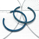Large crackled blue lucite hoop earrings.