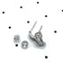 Silver and crystal hoop earrings on a polka dot background.