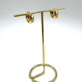 Gold and crystal hoop earrings on a gold stand.
