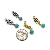 Silver and gold drop earrings with a quarter for scale.