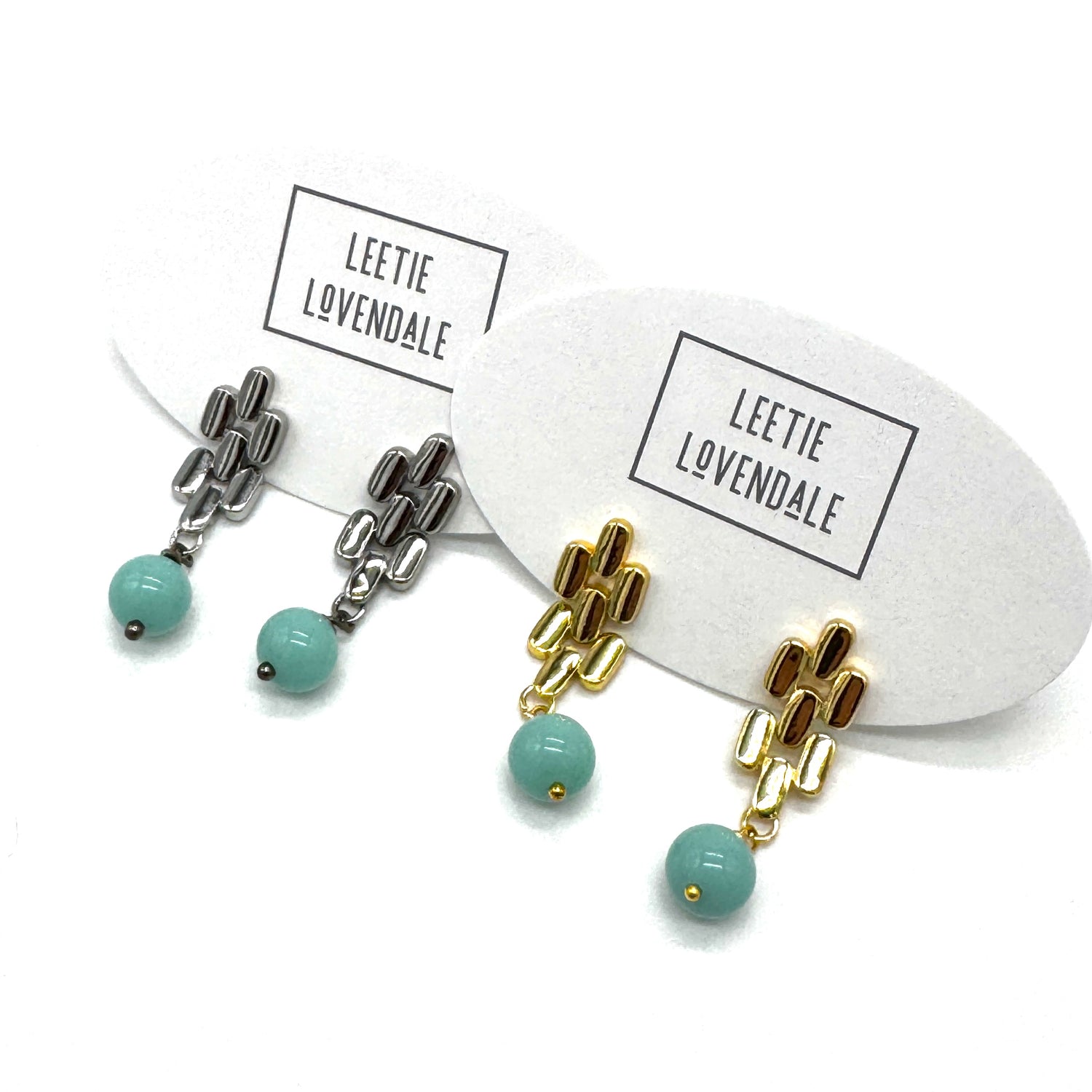 Silver and gold drop earrings with  turquoise glass beads.