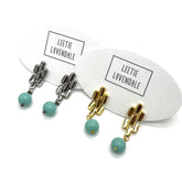 Silver and gold drop earrings with  turquoise glass beads.