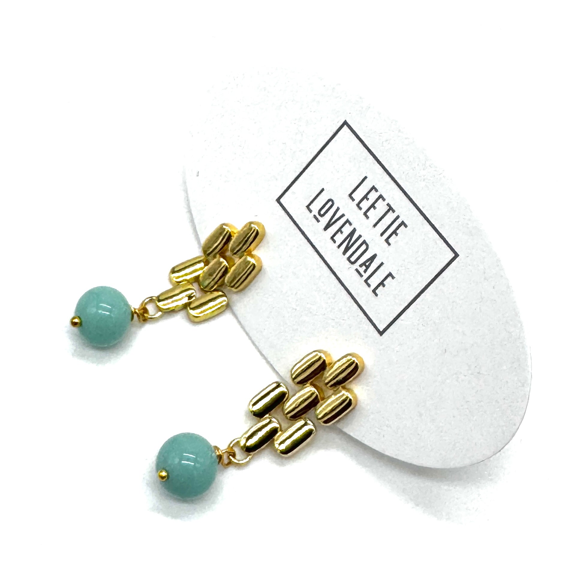 Gold drop earrings with a turquoise glass bead.