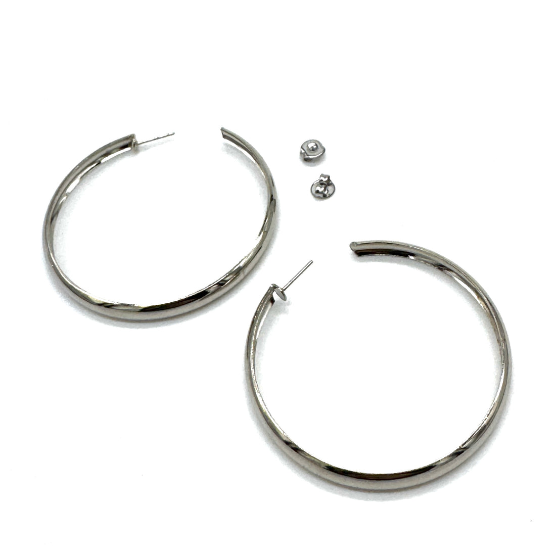 Large silver hoop earrings on a white background.
