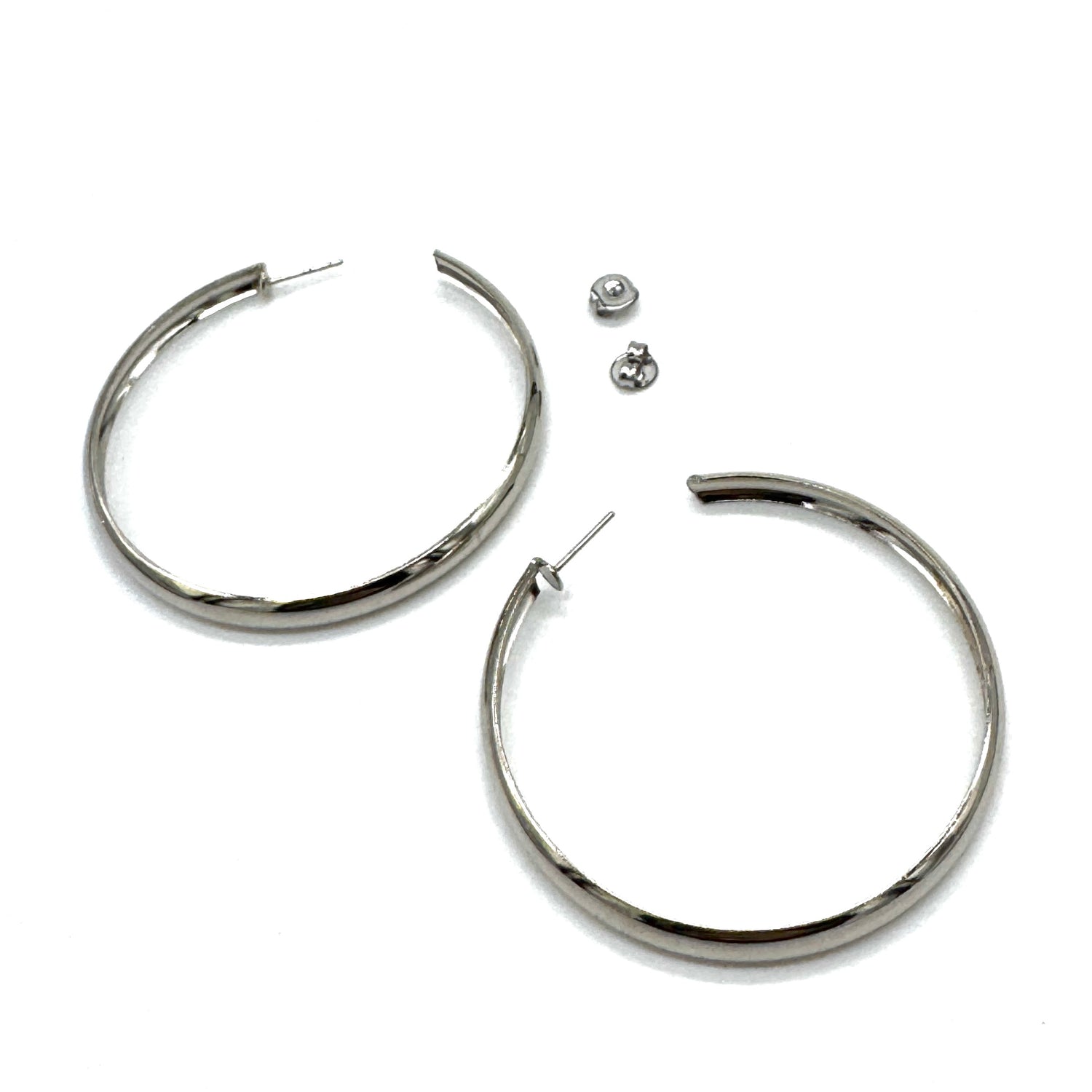 Large silver hoop earrings on a white background.