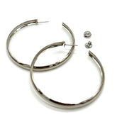 Large silver hoop earrings on a white background.
