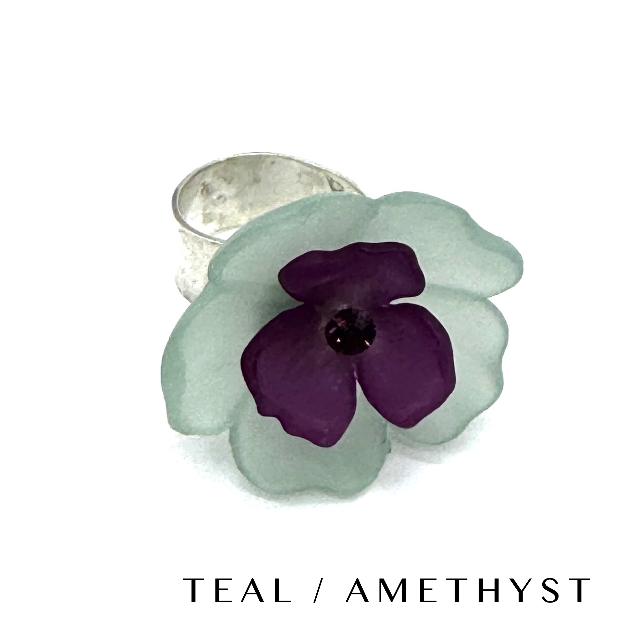 Floral cocktail ring on a white background labeled teal/amethyst.