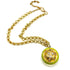 A gold chain necklace featuring a round pendant with a bright lime green outer ring and a textured gold center decorated with small clear rhinestones.