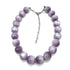 A beaded necklace made of smooth, round lavender-purple beads with a silver-tone chain extender clasp, displayed on a clean white background.