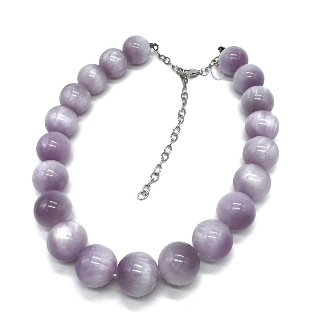 A beaded necklace made of smooth, polished lavender-purple round beads with a silver-tone chain extender clasp, displayed on a clean white background.