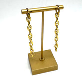 Gold-tone chain earrings displayed on a matching gold stand against a plain white background.