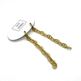 A pair of gold chain link earrings attached to a white display card, photographed on a clean white background.