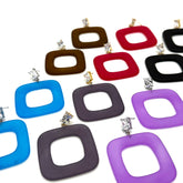 A collection of square-shaped drop earrings with rounded corners, featuring a hollow center and a small clear rhinestone stud at the top. The earrings are shown in multiple colors, including blue, dark gray, purple, red, brown, black, and purple, arranged on a plain white background.