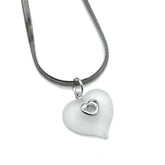 A silver snake chain necklace featuring a frosted white heart-shaped pendant with a small, polished silver heart inset in the center, shown against a plain white background.