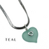 A teal heart-shaped pendant necklace with a silver snake chain and a small silver heart detail, shown on a white background with the word &