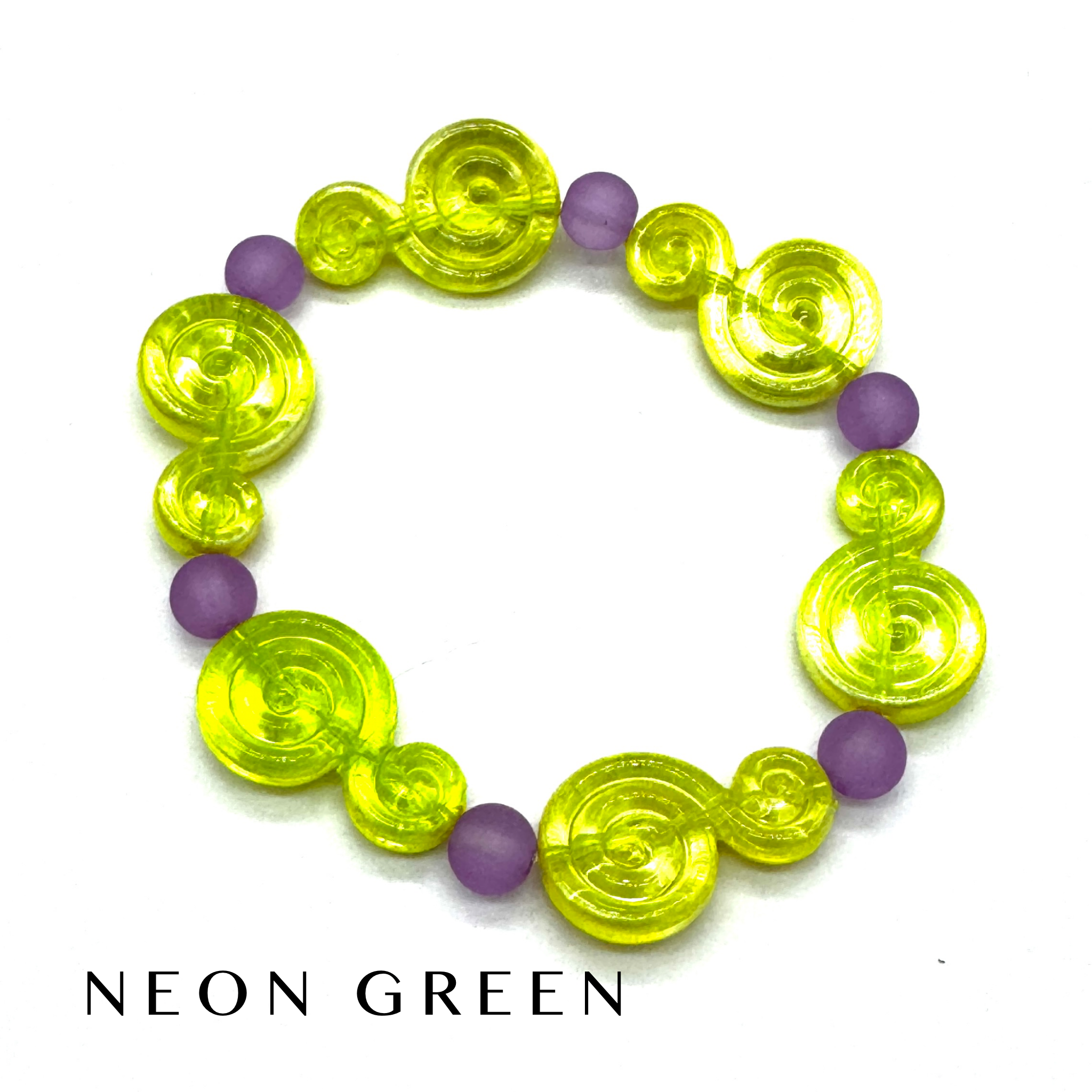 A beaded stretch bracelet featuring translucent neon green spiral-shaped beads and matte purple round beads, displayed on a white background with the text &