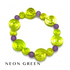 A beaded stretch bracelet featuring translucent neon green spiral-shaped beads and matte purple round beads, displayed on a white background with the text &