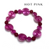 A beaded stretch bracelet featuring translucent hot pink spiral beads and matte dark pink round beads, displayed on a clean white background with &