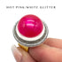Hot pink and white glittery ring on a finger with text &