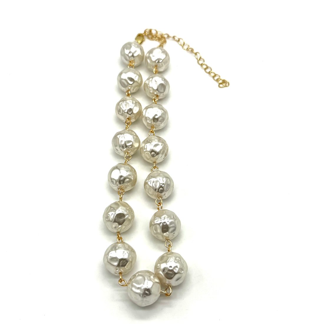 A pearl necklace with textured, hammered white pearls linked by gold-toned chains and connectors, featuring a gold-toned extender chain on a white background.