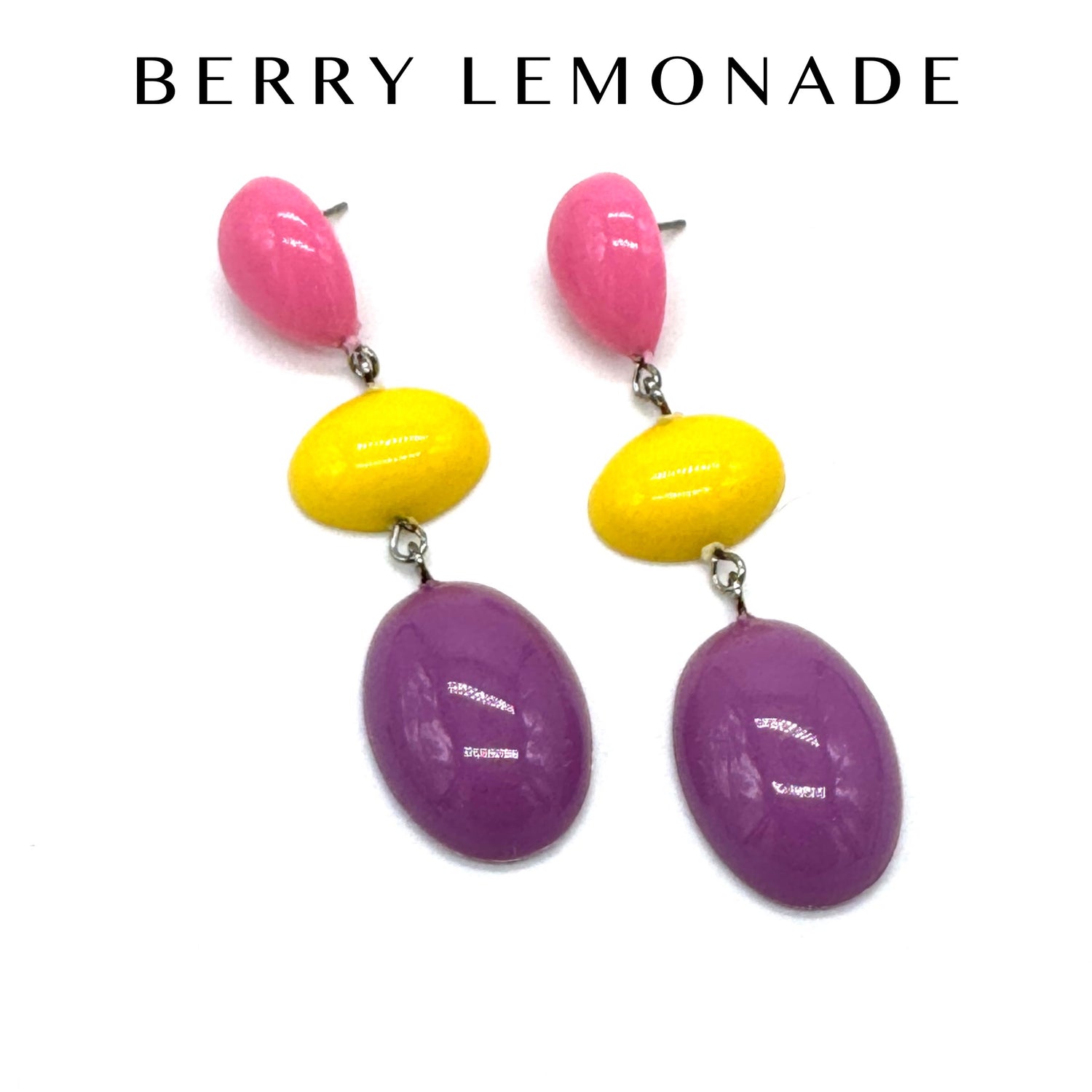 Colorful earrings with pink, yellow, and purple stones on a white background with &