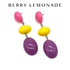 Colorful earrings with pink, yellow, and purple stones on a white background with &
