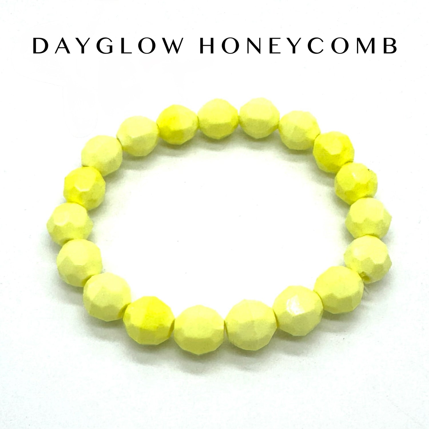 Yellow beaded bracelet on a white background with &