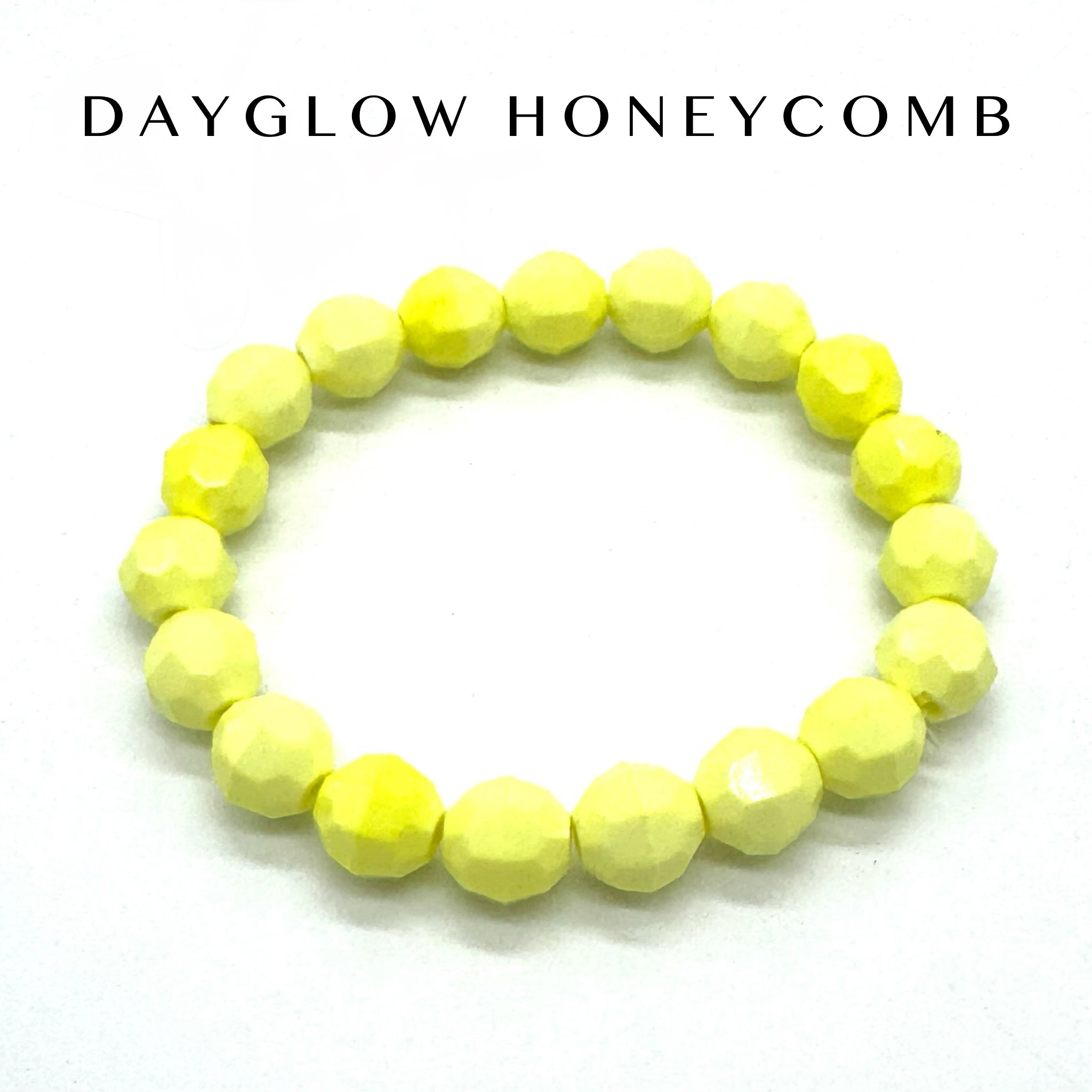 Yellow beaded bracelet on a white background with &