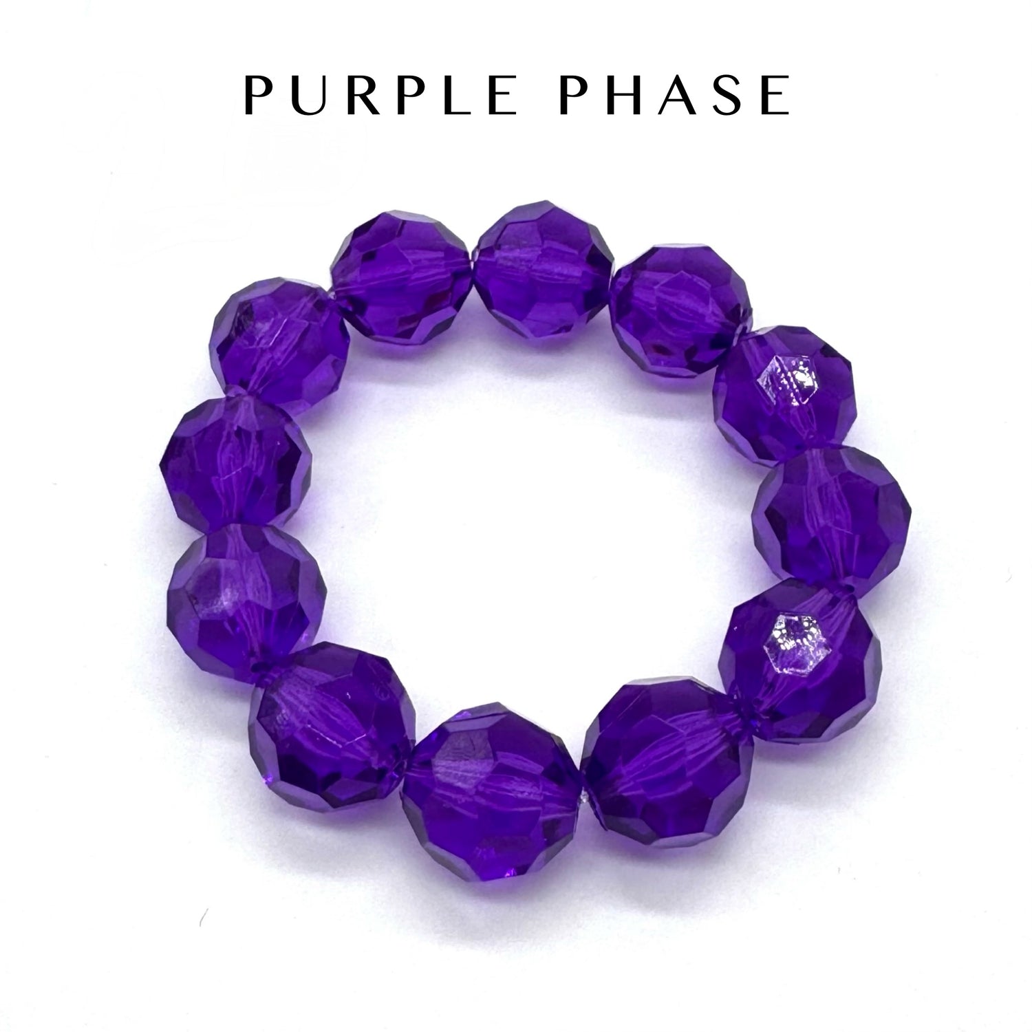 Purple beaded bracelet on a white background with &