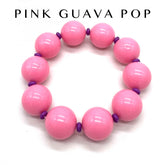 Pink beaded bracelet with purple accents on a white background, branded &